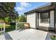 Exterior view of the back deck featuring white floors, wicker chairs and an entrance to the home at 7914 Trotwood Cir, Indianapolis, IN 46256