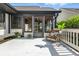 Back deck featuring white wooden floors and railings, a wicker chair and an entrance to the home at 7914 Trotwood Cir, Indianapolis, IN 46256