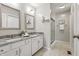 Bright bathroom featuring a double vanity with granite counters and glass shower at 7914 Trotwood Cir, Indianapolis, IN 46256