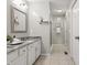Bathroom features double sinks with granite counters and a separate shower at 7914 Trotwood Cir, Indianapolis, IN 46256