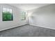 Bright bedroom with two windows, gray walls, and plush carpeting at 7914 Trotwood Cir, Indianapolis, IN 46256