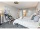 Cozy bedroom features a ceiling fan, stylish chair, and soothing gray walls at 7914 Trotwood Cir, Indianapolis, IN 46256