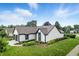 An attractive white home featuring a well-kept lawn and trimmed shrubbery in a lush community at 7914 Trotwood Cir, Indianapolis, IN 46256