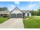 Charming single-story home with two-car garage, lush lawn, and inviting curb appeal at 7914 Trotwood Cir, Indianapolis, IN 46256