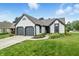 Charming home with two-car garage, manicured lawn, and inviting front entrance at 7914 Trotwood Cir, Indianapolis, IN 46256