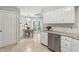Bright kitchen with stainless steel appliances, white cabinets, and eat-in dining area at 7914 Trotwood Cir, Indianapolis, IN 46256