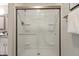 Clean, bright shower with clear glass doors and built-in shelves at 7914 Trotwood Cir, Indianapolis, IN 46256