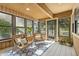 Bright sunroom featuring wicker chairs, tile flooring, and multiple windows for natural light at 7914 Trotwood Cir, Indianapolis, IN 46256