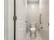 Neutral toilet room with white toilet and handy support bar for convenience at 7914 Trotwood Cir, Indianapolis, IN 46256