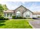 Traditional home showcasing stone accents, a well-maintained lawn, and a paved driveway to the garage at 7919 Cool Hollow Pl, Indianapolis, IN 46237