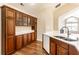 Well-lit kitchen featuring quartz countertops, stainless steel sink, and ample storage with dark wood cabinets at 7919 Cool Hollow Pl, Indianapolis, IN 46237