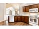 Modern kitchen with quartz countertops, stainless steel appliances, and dark wood cabinets at 7919 Cool Hollow Pl, Indianapolis, IN 46237