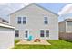 The home's backyard featuring a brick patio, light blue Adirondack chair, and wooden picnic table at 9593 W Constellation Dr, Pendleton, IN 46064