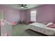 Cozy bedroom with lavender walls, carpeted floors, and a comfortable bed at 9593 W Constellation Dr, Pendleton, IN 46064
