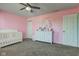 pink bedroom with a crib, ceiling fan and dresser at 9593 W Constellation Dr, Pendleton, IN 46064