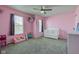 Pink themed bedroom featuring two windows, ceiling fan, and plush carpeting at 9593 W Constellation Dr, Pendleton, IN 46064