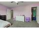 Spacious bedroom with lavender walls, carpeted floors, a closet, and a window at 9593 W Constellation Dr, Pendleton, IN 46064