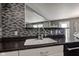 Modern kitchen with a stainless steel sink and faucet with stylish countertops and an elegant mosaic backsplash at 9593 W Constellation Dr, Pendleton, IN 46064