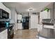 Fully equipped kitchen with stainless steel appliances, mosaic backsplash, countertops, and ample white cabinetry at 9593 W Constellation Dr, Pendleton, IN 46064