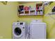 Close-up of the laundry area with a Samsung washer and dryer, plus open shelving for storage at 9593 W Constellation Dr, Pendleton, IN 46064