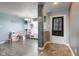 Open-concept living room with a tiled foyer, hardwood floors, and natural light streaming through the window at 9593 W Constellation Dr, Pendleton, IN 46064