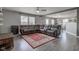 Bright and open living room with hardwood flooring, a large leather sectional sofa, and a cozy rug at 9593 W Constellation Dr, Pendleton, IN 46064