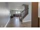 Inviting living room with hardwood floors, staircase, and open view to the living area with a comfortable leather sofa at 9593 W Constellation Dr, Pendleton, IN 46064