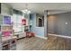 Open-concept living room with hardwood flooring, open shelving, and an entryway to the kitchen and foyer at 9593 W Constellation Dr, Pendleton, IN 46064