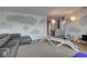 Open playroom with cloud murals, grey sofa, wooden play structure and lots of toys at 9593 W Constellation Dr, Pendleton, IN 46064