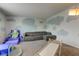Spacious carpeted playroom with whimsical cloud accents and a grey sofa at 9593 W Constellation Dr, Pendleton, IN 46064