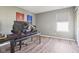 Bedroom/office features wood look flooring, natural light, and neutral walls at 9916 Gallop Ln, Fishers, IN 46040