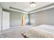 Bright bedroom boasts tray ceilings, neutral walls and carpet, plus an ensuite bathroom with glass shower door at 9916 Gallop Ln, Fishers, IN 46040