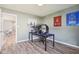 Bedroom/office features wood look flooring, natural light, and neutral walls at 9916 Gallop Ln, Fishers, IN 46040