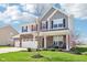 Beautiful home with a brick and siding exterior, a well-manicured lawn, and inviting front porch at 9916 Gallop Ln, Fishers, IN 46040