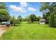 Large backyard with mature trees and a shed, perfect for outdoor activities and relaxation at 1013 Chapman Blvd, Greenfield, IN 46140