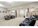 Spacious carpeted basement featuring seating areas and stairs to the main floor at 1013 Chapman Blvd, Greenfield, IN 46140