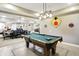 Spacious finished basement featuring a pool table, dining area, and decorative accents for entertainment at 1013 Chapman Blvd, Greenfield, IN 46140