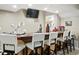 Basement bar with stylish white barstools and a TV, great for entertaining guests at 1013 Chapman Blvd, Greenfield, IN 46140