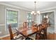 Bright dining room boasts hardwood floors, natural light, crown moulding, and decorative chandelier at 1013 Chapman Blvd, Greenfield, IN 46140