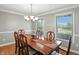 Elegant dining room featuring a beautiful wood table, chandelier lighting and large windows at 1013 Chapman Blvd, Greenfield, IN 46140