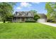 Charming brick home featuring a welcoming front porch and well-maintained landscaping at 1013 Chapman Blvd, Greenfield, IN 46140