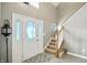 Inviting foyer with a staircase, tiled floors, and a decorative front door at 1013 Chapman Blvd, Greenfield, IN 46140