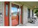 Charming front porch featuring a glass door, brick accents, and outdoor seating at 1013 Chapman Blvd, Greenfield, IN 46140