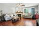 Cozy living room with hardwood floors, fireplace, ceiling fan, and comfortable seating at 1013 Chapman Blvd, Greenfield, IN 46140