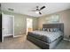 Bedroom features a queen size bed, ceiling fan, and ensuite bathroom at 1013 Chapman Blvd, Greenfield, IN 46140