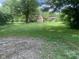 Large, green backyard with mature trees and an outbuilding offers great potential at 106 N 300 W, Greenfield, IN 46140