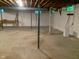 Unfinished basement with concrete floor and visible ceiling beams, ready for customization at 106 N 300 W, Greenfield, IN 46140
