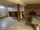 Partially finished basement area with retro style wet bar and seating, plus fireplace feature at 106 N 300 W, Greenfield, IN 46140