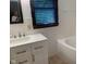 Bathroom featuring a new vanity, mirror, and a tub with white tiles, offering a clean and modern design at 106 N 300 W, Greenfield, IN 46140
