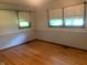 Bedroom with hardwood floors, two windows providing natural light, and neutral-colored walls at 106 N 300 W, Greenfield, IN 46140